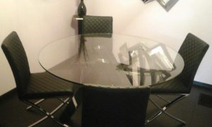 Designer glass top table and chair delivered by our White leather couch delivered by our Nationwide Furniture Delivery team.